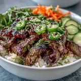 Vibrant Korean Beef Power Bowl ingredients prepped in bowls: marinated beef, crisp veggies, and spicy mayo sauce for assembly.