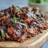 Sumptuous Juneteenth BBQ Pulled Pork piled high with a refreshing, crisp watermelon slaw for grilling.