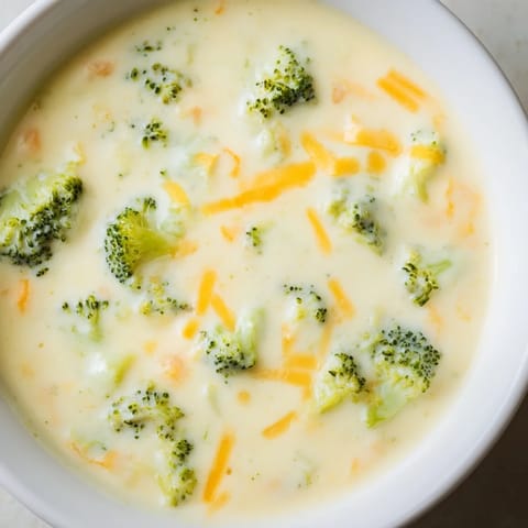 Creamy, vibrant Broccoli Cheese Soup with visible chunks of broccoli, ready to eat.