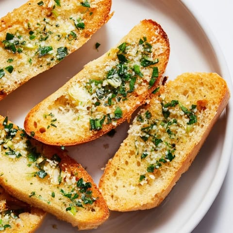 Golden, crispy garlic bread, perfect with pasta, and generously brushed with herb-infused butter.
