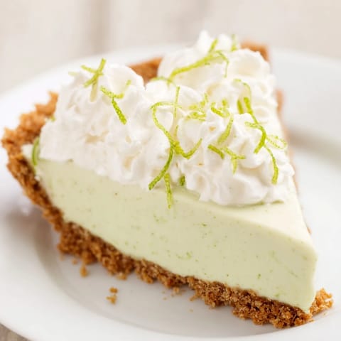 This Key Lime Pie shows off a perfectly browned crust and a vibrant green filling.