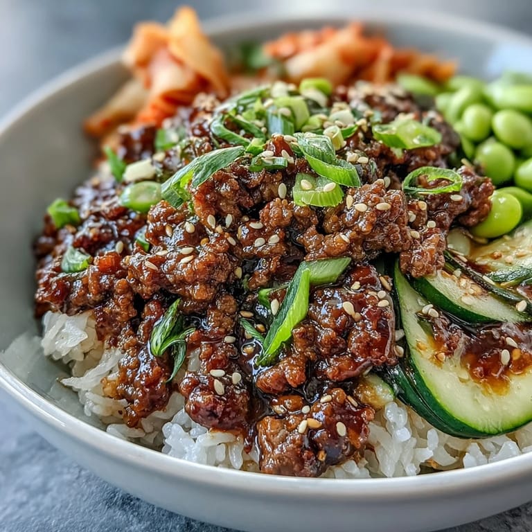 Korean Ground Beef Bowl featuring gochujang beef, crisp carrots, cucumbers, and edamame.