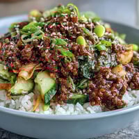 Korean Ground Beef Bowl with steamed rice, vibrant kimchi, and fresh sesame toppings.