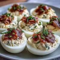 Smoked Salmon Deviled Eggs with Everything Seasoning: Creamy yolk filling topped with flaky smoked salmon and crunchy everything bagel spice.