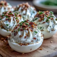 Golden-brown Everything Bagel Deviled Eggs topped generously with crunchy seasoning.